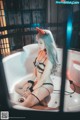 A woman sitting in a bathtub in a bathroom.