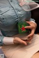 A woman holding a can of beer in her hands.