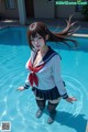 A woman in a sailor outfit standing in a pool.